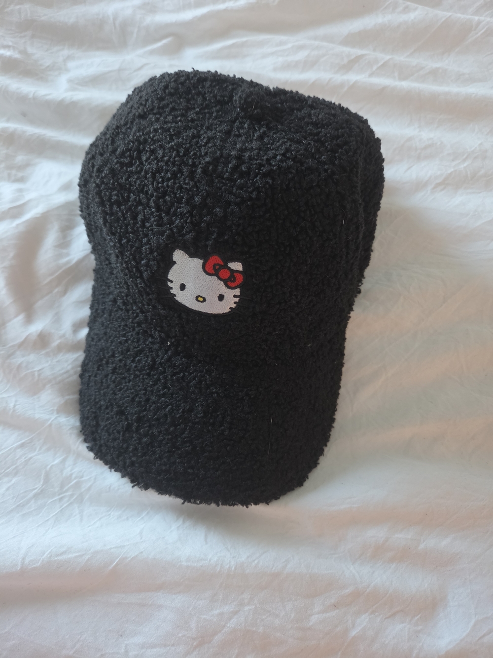 Bioworld Hello Kitty Black Sherpa Cap with Red Bow Accent